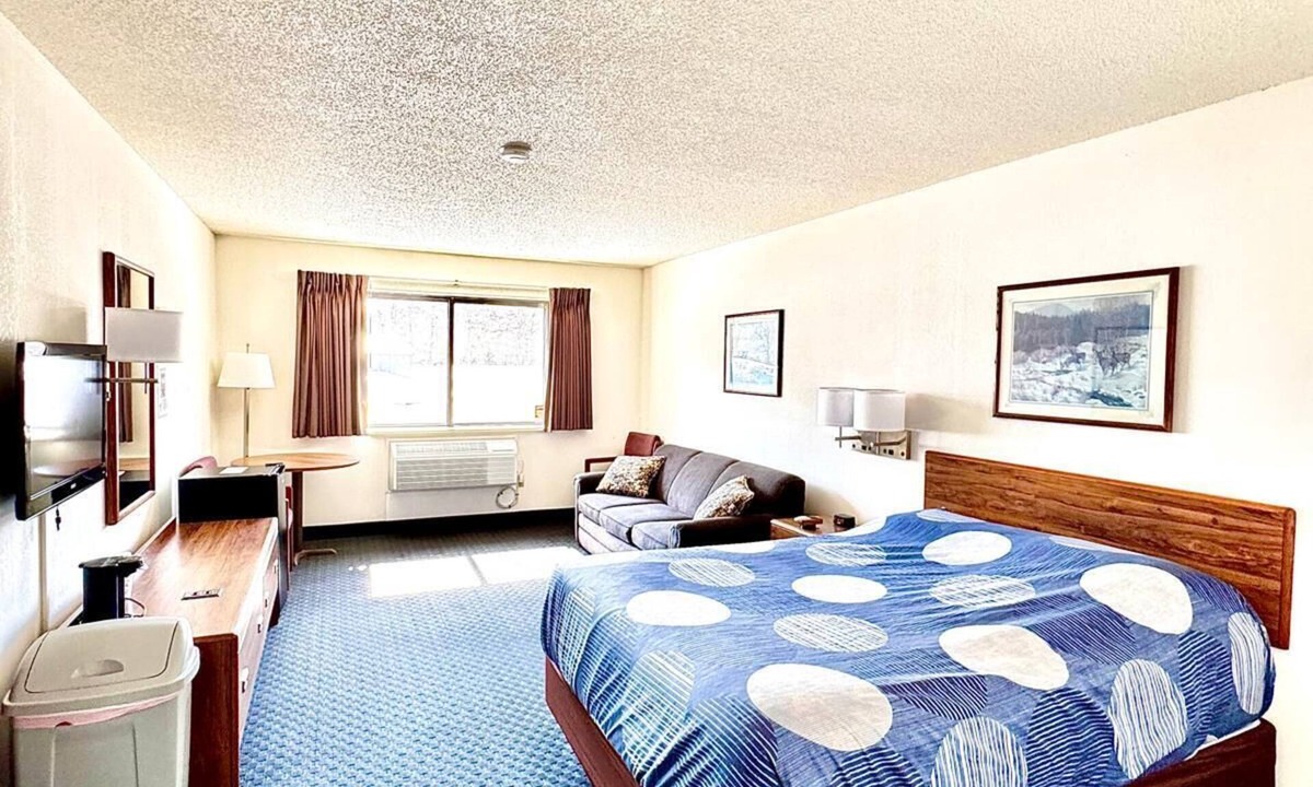 Boulder Junction Apartment | One queen bed, private bathroom with jetted tub, mini fridge, and single-serve coffee maker.