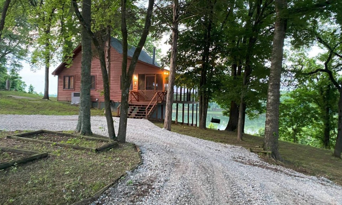 Pleasant Grove Cabin | Riverfront cabin with hot tub and amenities galore!