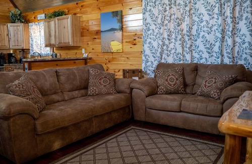 Gepp Cabin | Cabin featuring a vaulted ceiling, a large porch, and huge patio with fire pit.