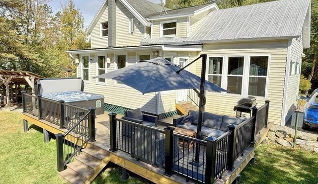 Inviting riverfront home with hot tub on deck & fireplace, near skiing & golf